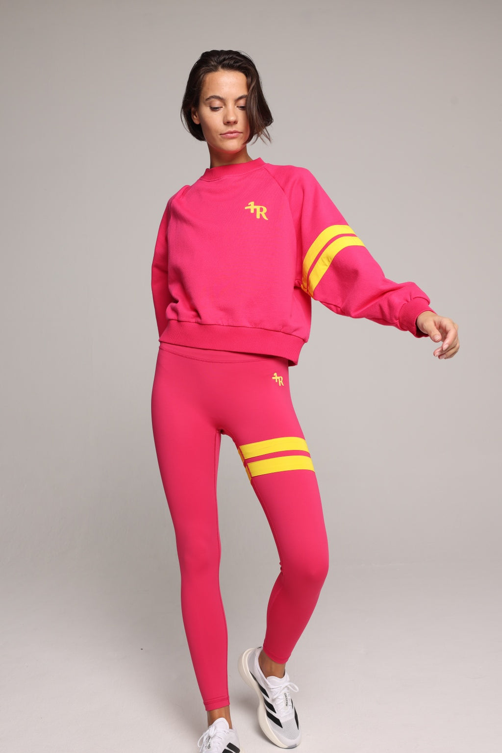 woman wearing premium pink organic crew sweater and pink performance leggings with yellow stripes by One More Reason, women's luxury activewear indoor set