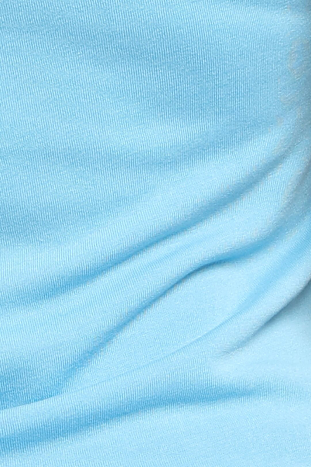 A close-up of light blue ribbed knit fabric with soft folds and a smooth texture.