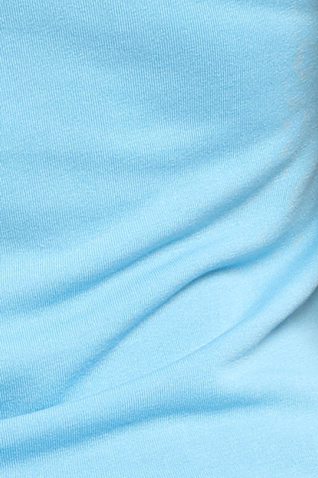 A close-up of light blue ribbed knit fabric with soft folds and a smooth texture.