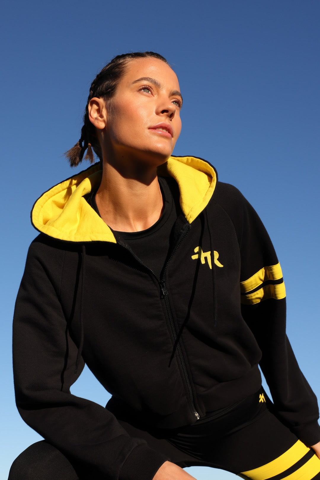 woman in bicolor black performance jacket zip hoodie  with yellow stripes top premium luxury activewear by One More Reason high-performance fitness apparel
