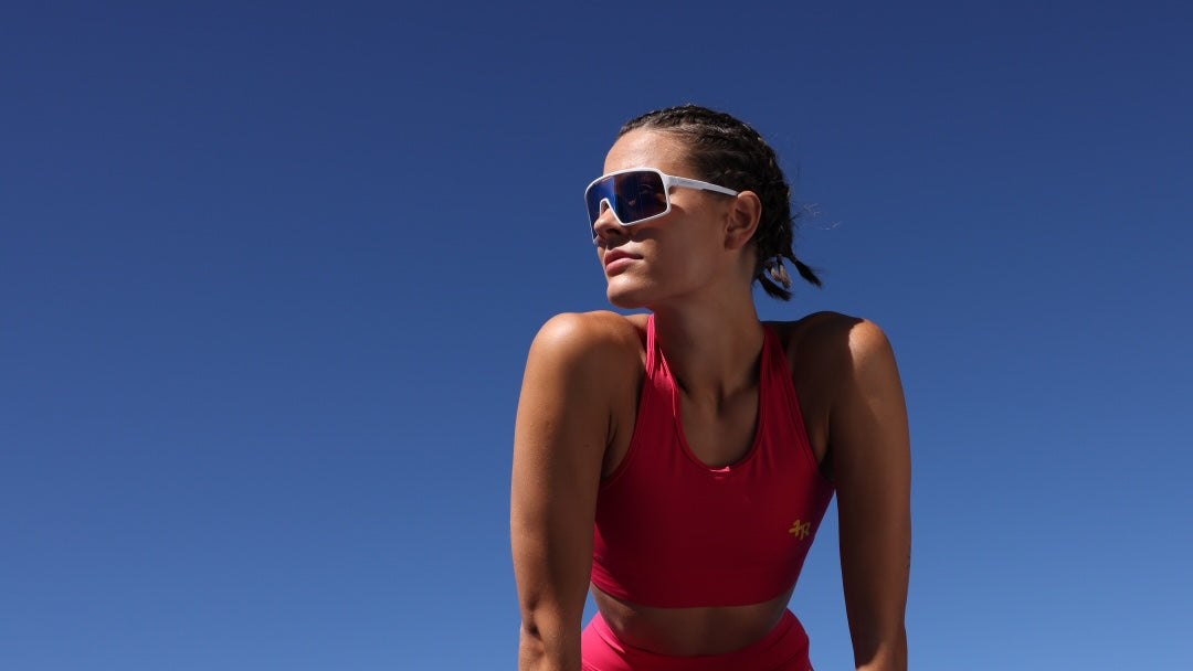 Woman wearing premium sportswear by one more reason pink tank top outdoor setting