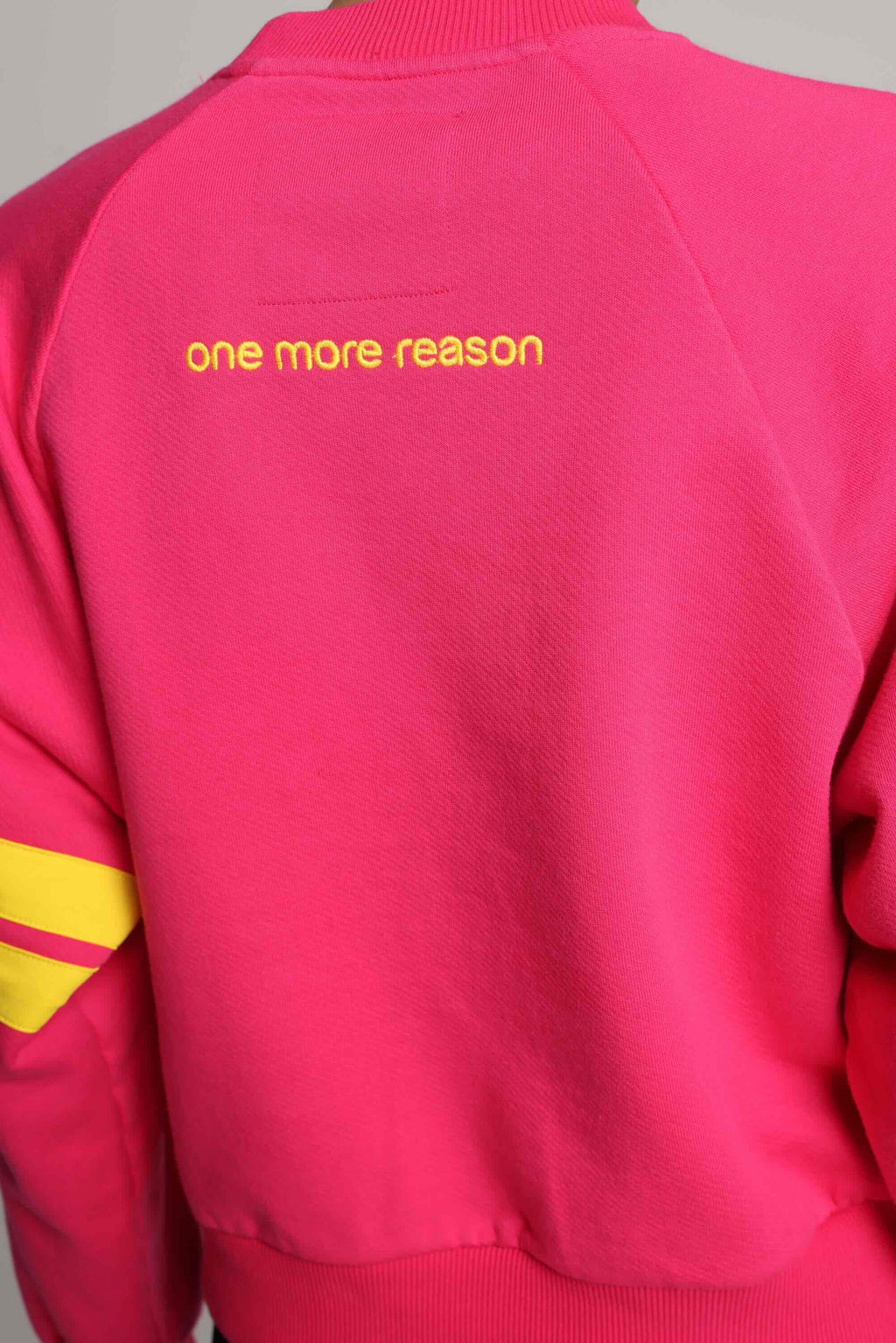 woman wearing premium pink organic crew sweater with yellow stripes by One More Reason, women's luxury activewear indoor set