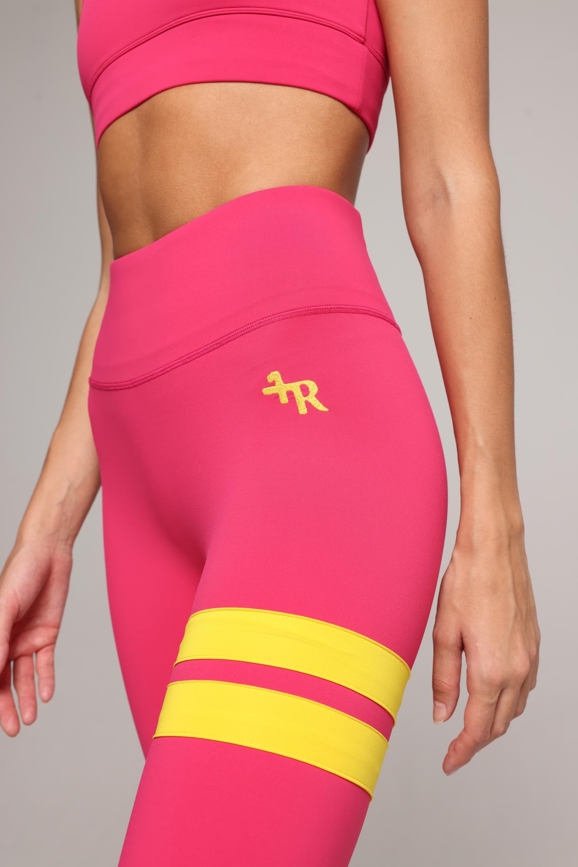 woman wearing premium pink leggings with yellow stripes by One More Reason, women's luxury activewear indoor set