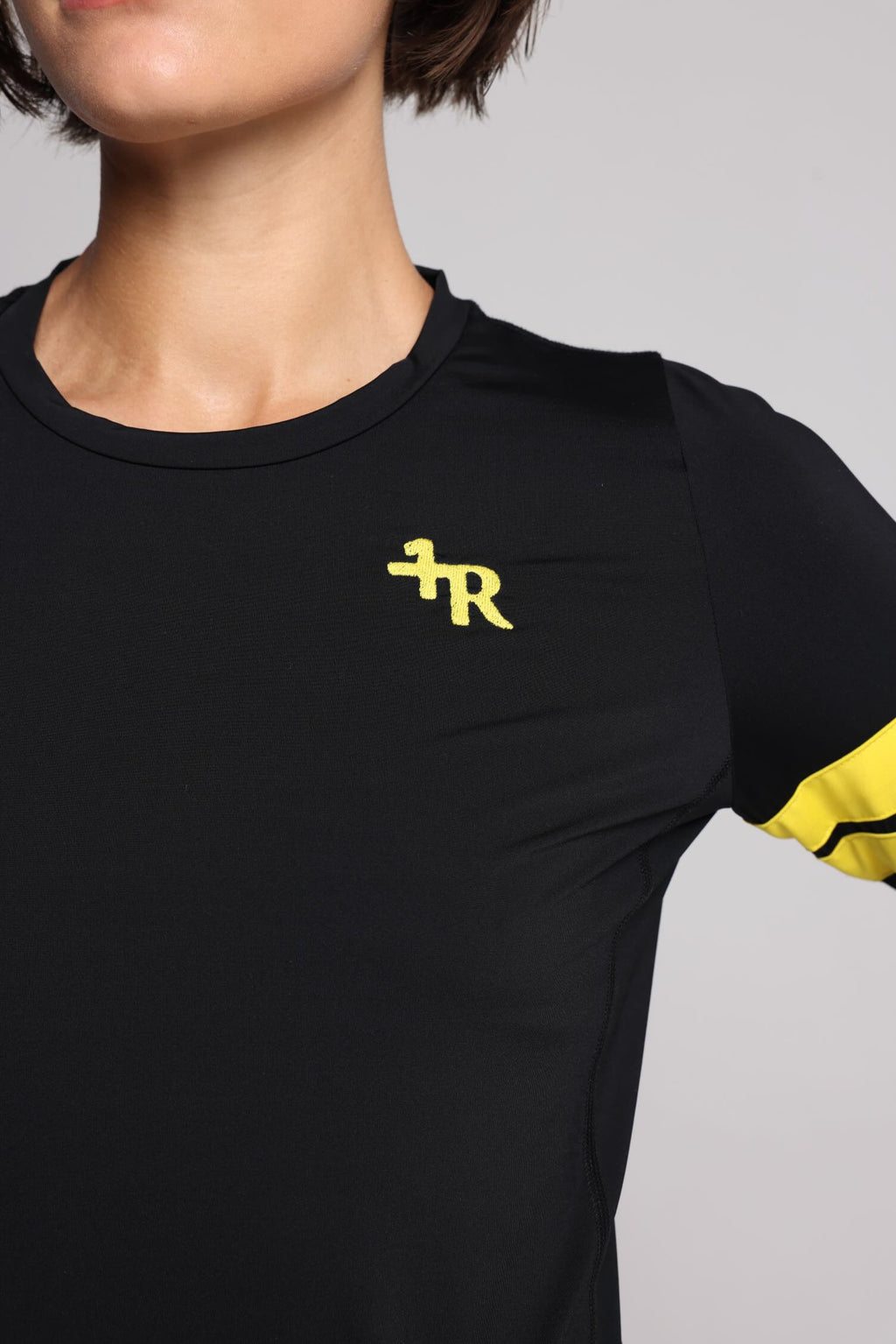 women in black long sleeve performance top with yellow stripes top premium luxury activewear by One More Reason high-performance fitness apparel