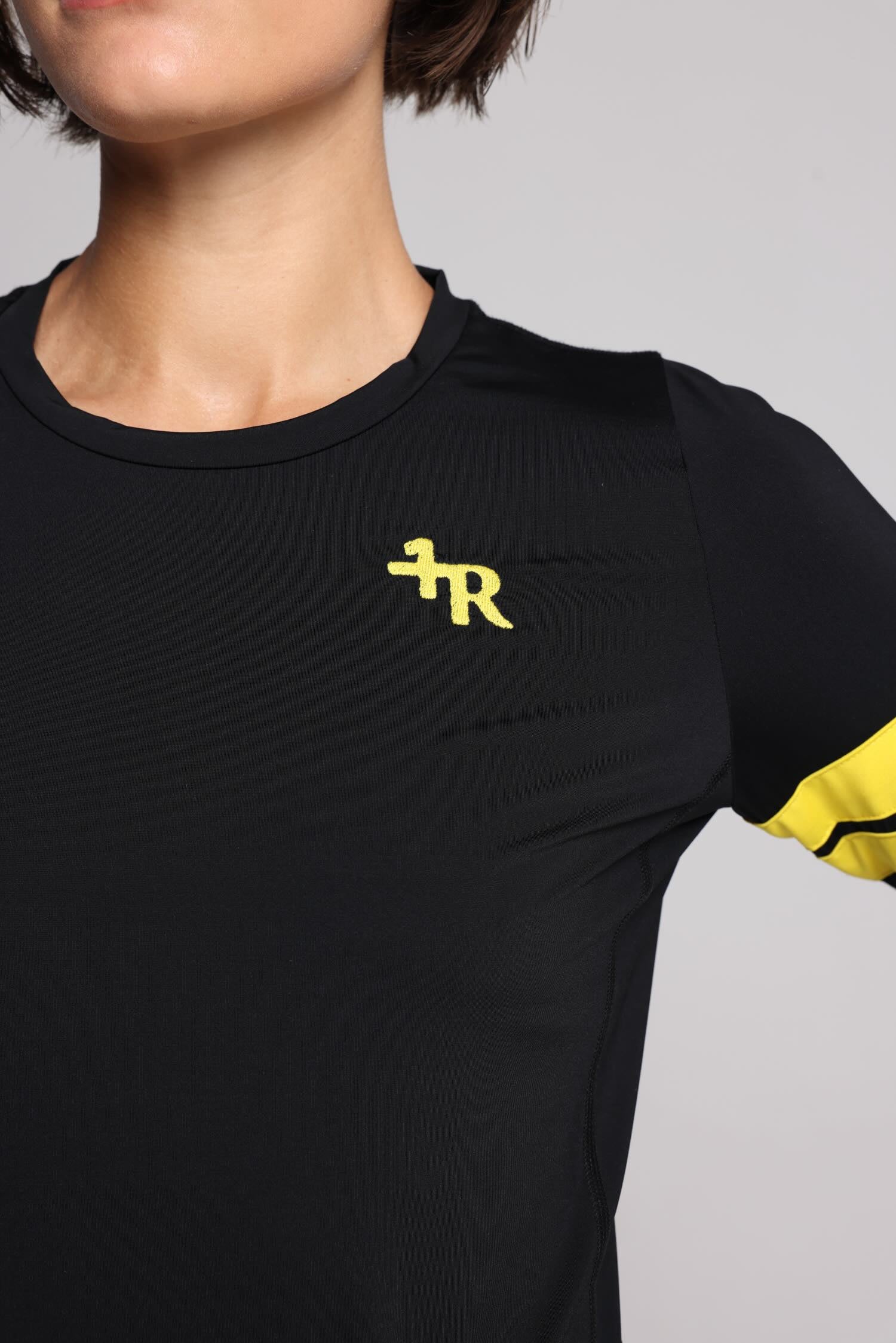 women in black long sleeve performance top with yellow stripes top premium luxury activewear by One More Reason high-performance fitness apparel