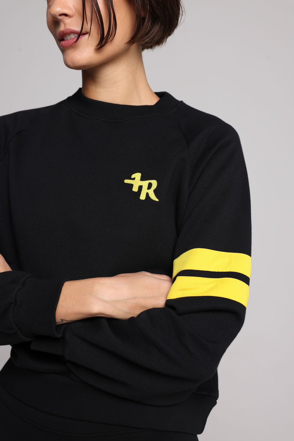 women in black cotton crew sweater with yellow stripes top premium luxury activewear by One More Reason high-performance fitness apparel
