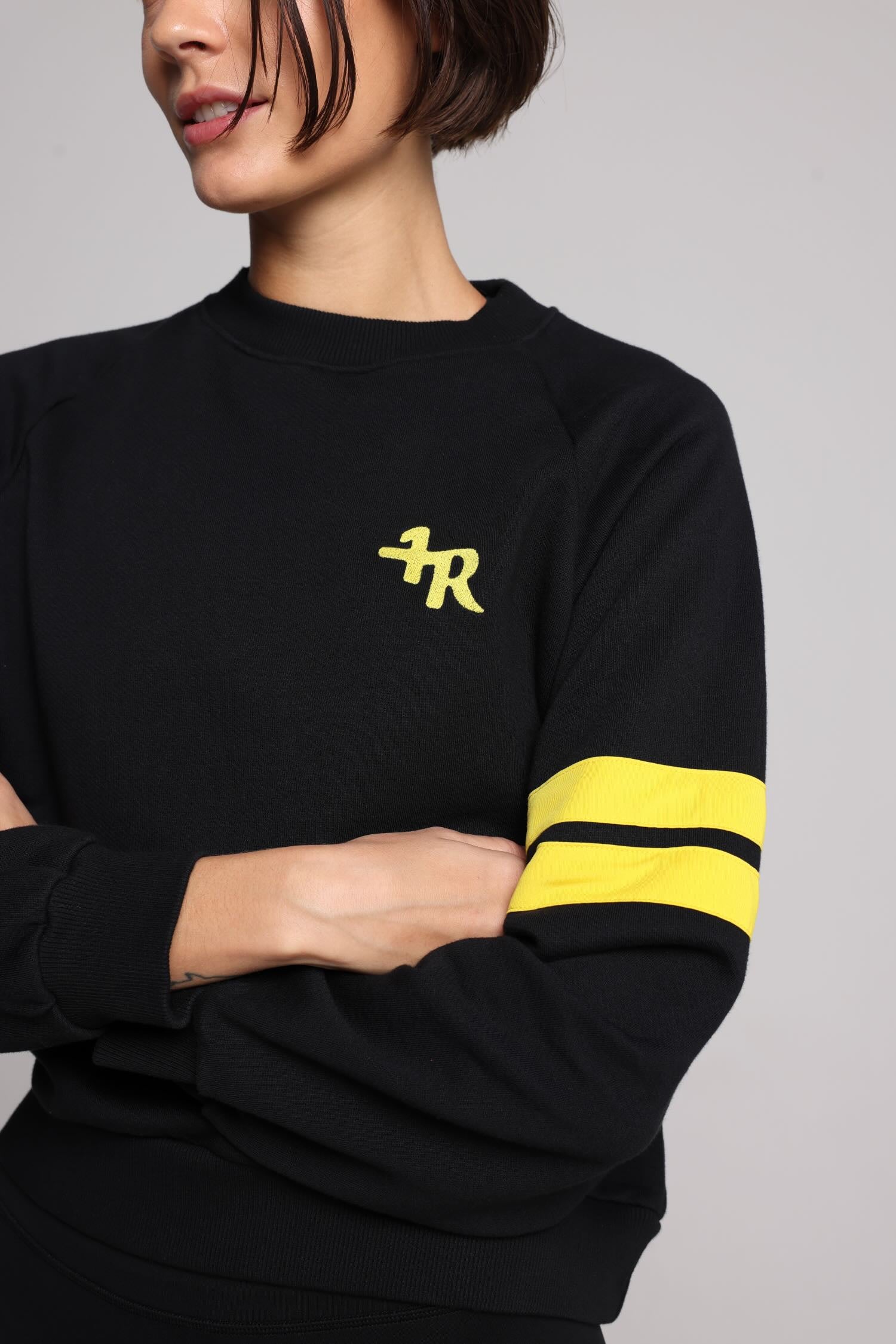 women in black cotton crew sweater with yellow stripes top premium luxury activewear by One More Reason high-performance fitness apparel